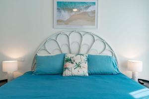 a bedroom with a blue bed with a white headboard at 5 Tabernacle Rd Encounter Bay- No Linen Included in Encounter Bay