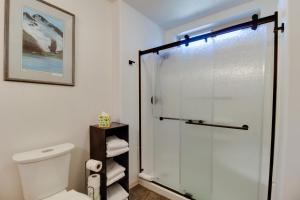 a bathroom with a toilet and a glass shower at Timber Creek Escape in Sisters +43 photos