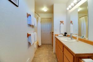 a bathroom with a sink and a mirror at Timber Creek Escape in Sisters +15 photos