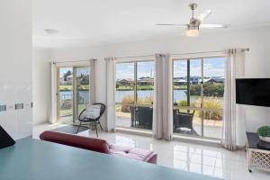 a living room with a view of the water at T2 12 Wentworth Pde Hindmarsh Island - No Linen Included in Hindmarsh Island