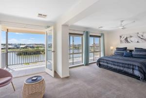 a bedroom with a bed and a balcony at T2 12 Wentworth Pde Hindmarsh Island - No Linen Included in Hindmarsh Island