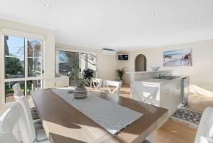 a kitchen and dining room with a table and chairs at BONAVIVE Port Elliot - Luxury - Family - Township - No Linen Included in Port Elliot