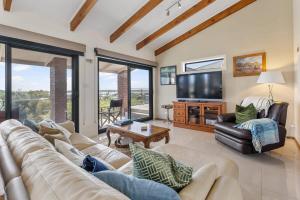 a living room with a couch and a tv at 20 Sir George Ritchie Ave Goolwa South - No Linen Included in Goolwa South