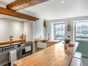 a kitchen with a wooden counter top in a room at Dee Bank Cottage in Llangollen