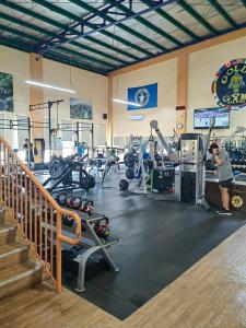 a gym with treadmills and machines in a room at Discovery Saipan Hotel in Garapan