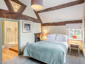 a bedroom with a bed and a fireplace at Ye Ol Tavern in Ruthin