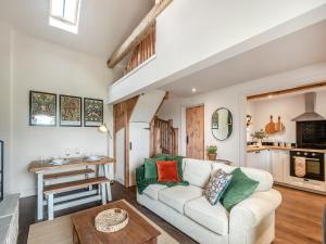 a living room with a couch and a table at The Hay Loft - Uk45607 in Sigglesthorne