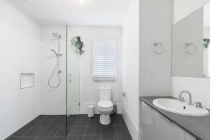 a white bathroom with a toilet and a sink at Serendipity - 27 Shields Crs Encounter Bay - No Linen Included in Encounter Bay +25 photos