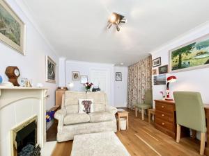 a living room with a chair and a fireplace at St, Andrews Mews in Wells