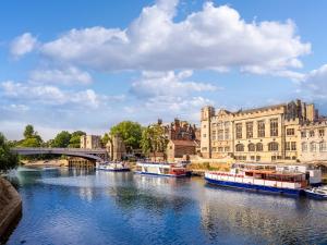 a river with boats in a city with buildings at Lanburnum Lodge - Uk47076 in Wilberfoss