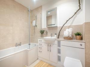 a bathroom with a sink and a tub and a toilet at The Wabi-sabi Sanctuary in Arford