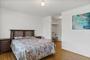 a bedroom with a bed and a painting on the wall at Where the River meets the Sea 66 Colman Rd Goolwa-No Linen Included in Goolwa South