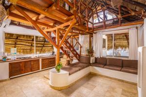 a large living room with wooden ceilings and windows at Hotel Villas Sayulita in Sayulita