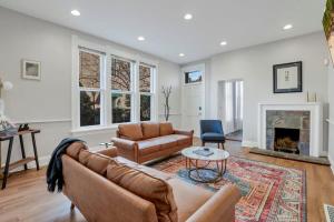 a living room with a couch and a fireplace at Housepitality - The Capital House - 5 BR Downtown in Columbus