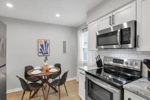 a kitchen with a table and a stove top oven at The Schumacher Townhouse - 2 BR in Columbus