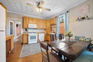 a kitchen and dining room with a wooden table at The Village Townhouse - 5 BR in Columbus