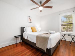 a bedroom with a bed and a ceiling fan at Housepitality - The Cobblestone 2- New Renovation in Columbus +11 photos
