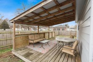 eine Terrasse mit einem Tisch und Stühlen auf einer Holzterrasse in der Unterkunft Housepitality - The Restful Studio - Cozy in Newark