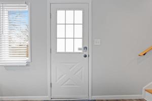 a white door in a room with a window at Housepitality - The Restful Studio - Cozy in Newark