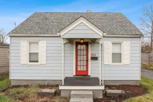 a small white house with a red door at Housepitality - Newark Friends and Family House in Newark +40 photos