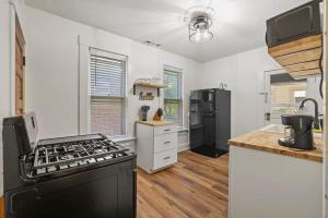 a kitchen with a stove and a refrigerator at Housepitality - Cityscape - Historic 2BR in Columbus