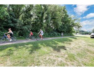 a group of people riding bikes down a road at Housepitality - Little River Trails in Mason