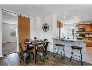 a dining room and kitchen with a table and chairs at Housepitality - Little River Trails in Mason