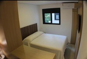 a small bedroom with a bed and a window at Fabio Av Paulista in São Paulo