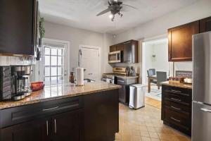 a kitchen with black cabinets and stainless steel appliances at The Skyline Cottage - 3 BR Garage in Columbus