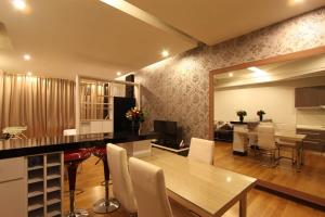 a dining room and living room with a table and chairs at Kuala Lumpur Regalia Deluxe Suite in Kuala Lumpur