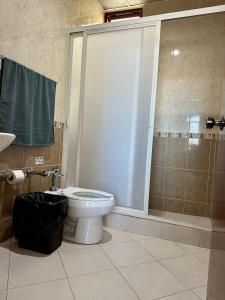 a bathroom with a toilet and a shower at Hotel Hacienda el Edén in San Juan de los Lagos