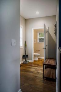 a room with a bathroom with a toilet and a door at Housepitality - The Lilley Pad - Near Downtown in Columbus