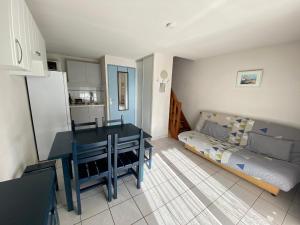 a kitchen with a table and a couch in a room at Maison Vendres, 3 pièces, 6 personnes - FR-1-781-40 in Port-Vendres
