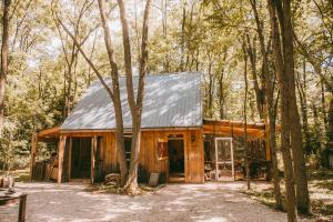 a log cabin in the woods with trees at The Walnut Grove BnB in Harrow