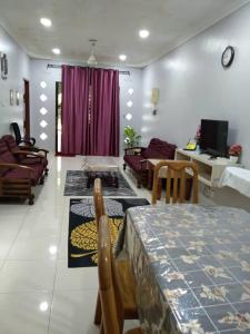 a living room with a table and a couch at ZR Homestay Kemaman with 3 Bedroom 2 Bathroom - 2 Room AC 1 Room Fan - Not Sharing House in Cukai