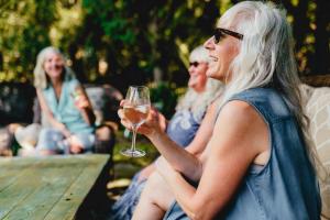 a woman holding a glass of wine at The Walnut Grove BnB in Harrow