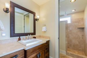 a bathroom with a sink and a shower at E111 Ground Floor Poolside Patio in Koloa