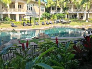 a swimming pool at a hotel with a resort at E111 Ground Floor Poolside Patio in Koloa