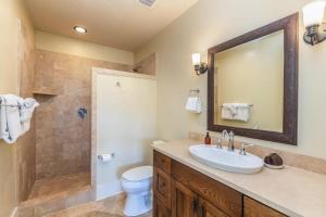 a bathroom with a sink and a shower at E111 Ground Floor Poolside Patio in Koloa +15 photos