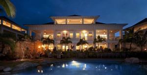 a large white building with a swimming pool at night at C300 Custom 4 bedroom Ocean View Penthouse in Koloa