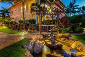 a water fountain in front of a building at C300 Custom 4 bedroom Ocean View Penthouse in Koloa