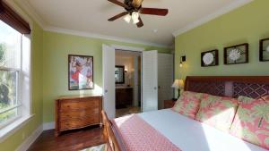 a bedroom with a bed and a ceiling fan at D210 Second Floor 3-bedroom Poolside Lanai in Koloa