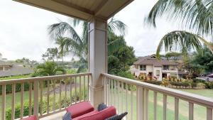 a balcony with a view of a house at D210 Second Floor 3-bedroom Poolside Lanai in Koloa +28 photos