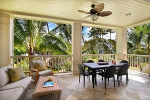 a screened in porch with a table and chairs at D211 Second Floor 3-bedroom Poolside Lanai in Koloa