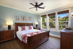 a bedroom with a bed and a ceiling fan at D211 Second Floor 3-bedroom Poolside Lanai in Koloa