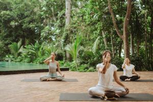 a group of people sitting in a yoga class at Titik Dua Ubud in Ubud