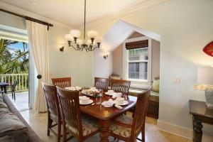 a dining room with a table and chairs at D211 Second Floor 3-bedroom Poolside Lanai in Koloa +18 photos