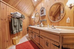 a bathroom with a sink and a mirror at Holiday House in Rapid City