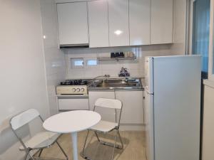 a kitchen with a table and chairs and a refrigerator at hongdae housing line 2 st 1 min in Seoul