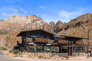 a large building with mountains in the background at Zion loft with canyon views - unit 2 in Springdale